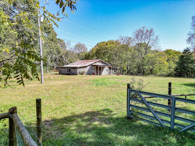 view of yard with an outbuilding and a rural view