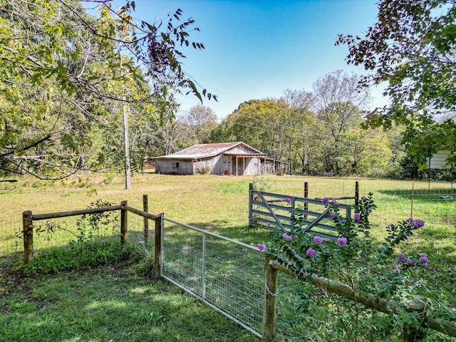 view of yard with a rural view and an outdoor structure