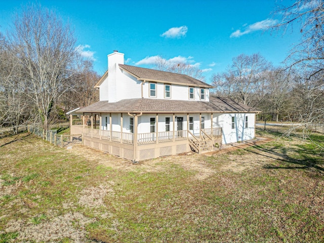 back of property featuring a porch and a yard