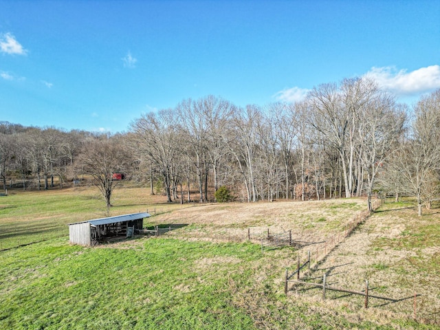 view of yard with a rural view and an outdoor structure