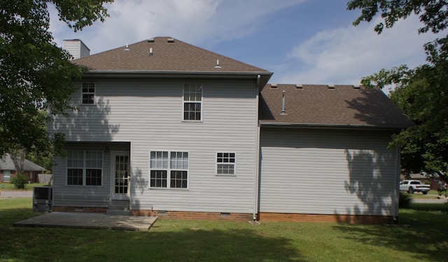 rear view of property featuring a patio and a lawn