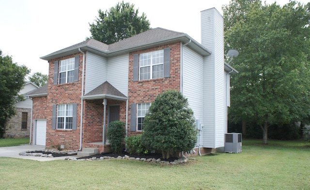 view of front of home with a front yard and central AC