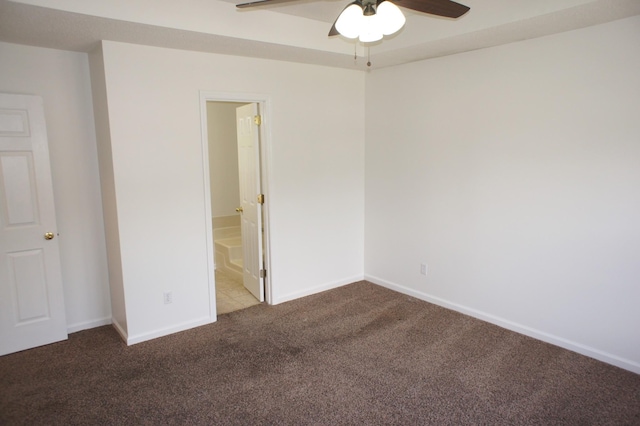 carpeted spare room featuring ceiling fan