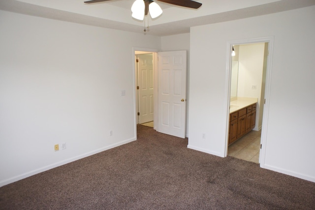 unfurnished bedroom featuring ceiling fan, light colored carpet, and ensuite bathroom