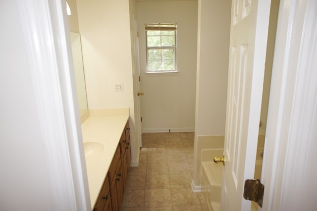 bathroom with a tub to relax in and vanity