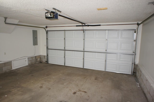 garage with electric panel and a garage door opener