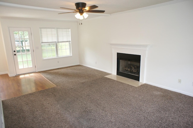 unfurnished living room featuring ceiling fan, carpet, and ornamental molding