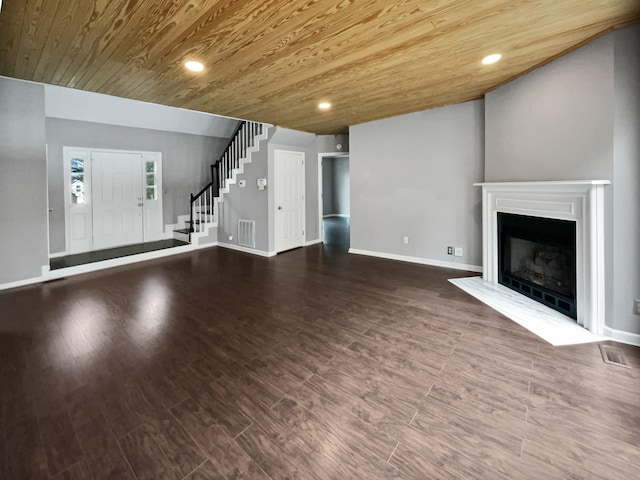 unfurnished living room featuring dark wood-type flooring and wooden ceiling