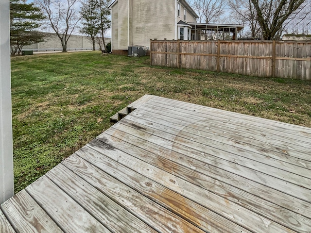 wooden deck featuring central AC unit and a lawn