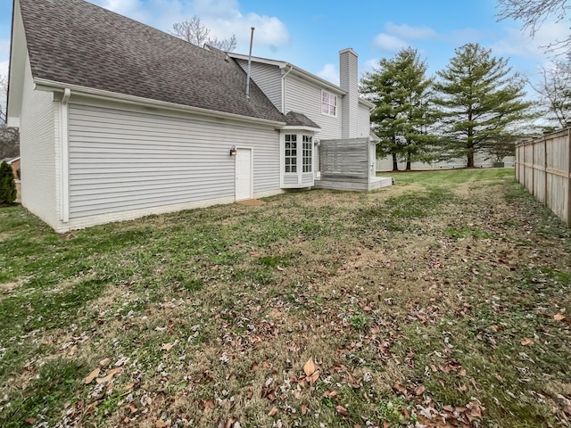 back of house featuring a lawn