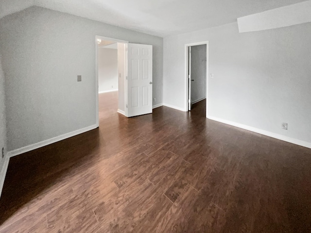 empty room with dark wood-type flooring