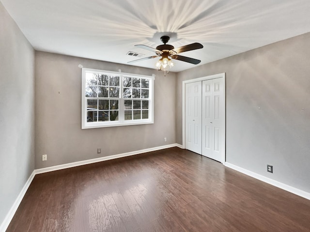 unfurnished bedroom with a closet, ceiling fan, and dark hardwood / wood-style floors