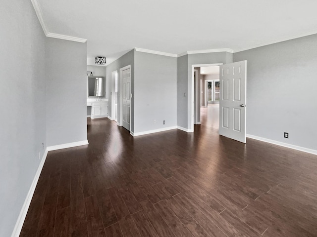 spare room with crown molding, dark wood-type flooring, and a wealth of natural light