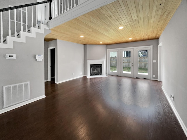 unfurnished living room featuring dark wood-type flooring and wooden ceiling