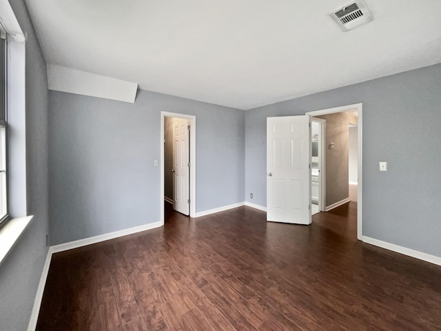 spare room with dark hardwood / wood-style floors