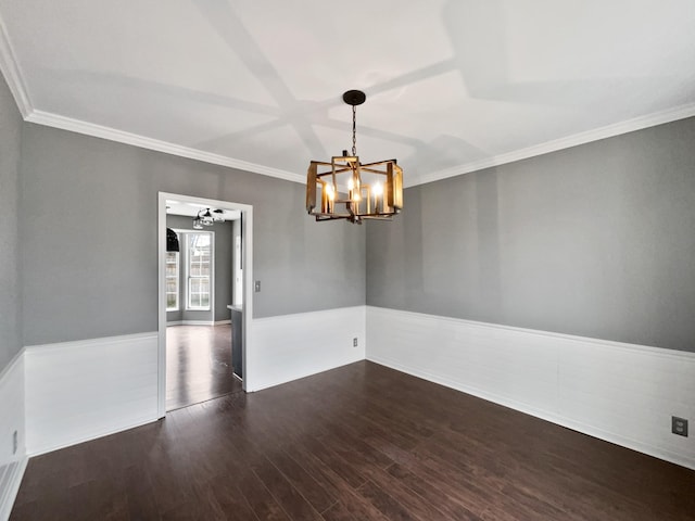 unfurnished room with a chandelier, crown molding, and dark wood-type flooring