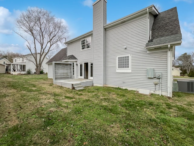 back of property featuring a yard