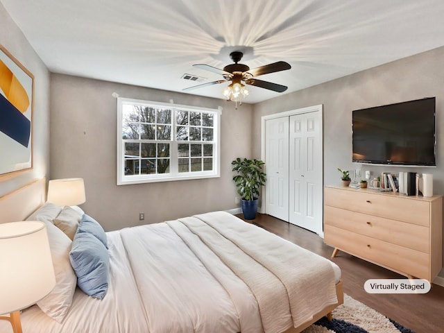 bedroom with dark hardwood / wood-style flooring, a closet, and ceiling fan