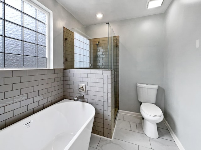 bathroom featuring separate shower and tub and toilet