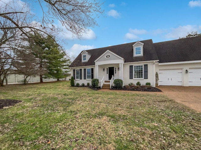 cape cod home featuring a front yard and a garage