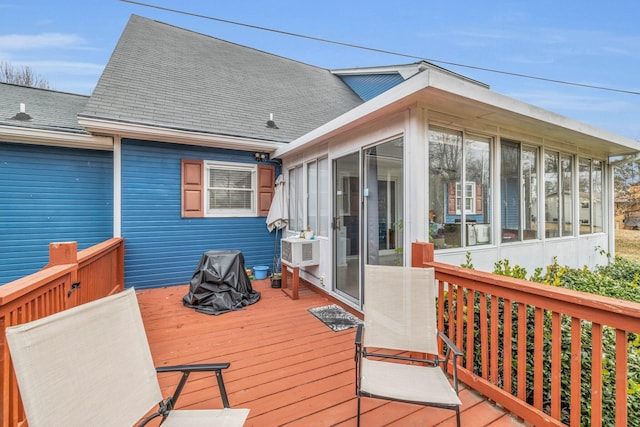 wooden deck featuring a sunroom