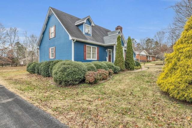 view of property exterior with a lawn