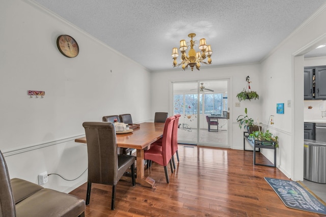 dining area with hardwood / wood-style flooring, ceiling fan with notable chandelier, ornamental molding, and a textured ceiling