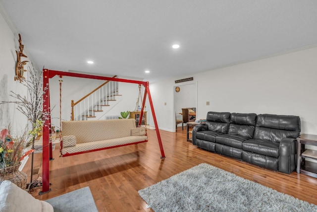 living room with hardwood / wood-style floors and ornamental molding