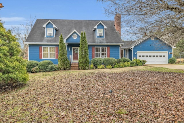 new england style home featuring a garage