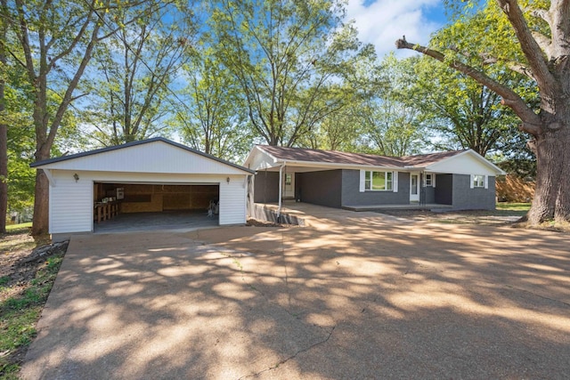 single story home featuring an outdoor structure and a garage