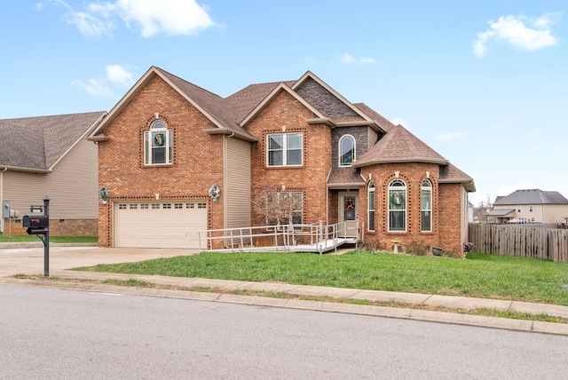 view of front of home with a front yard and a garage