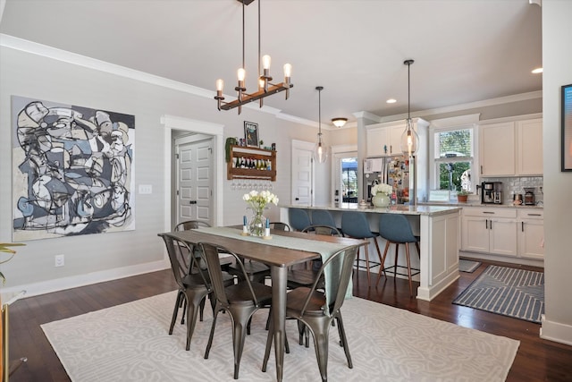 dining space featuring a chandelier, dark hardwood / wood-style floors, and crown molding