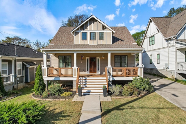 view of front of home with covered porch and a front yard