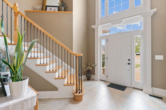 entryway featuring a towering ceiling