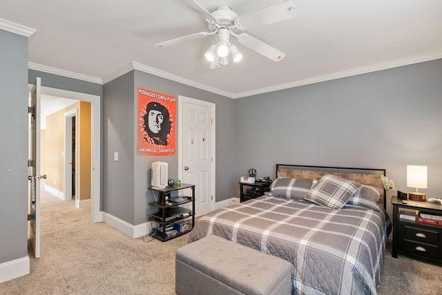 carpeted bedroom with ceiling fan and ornamental molding