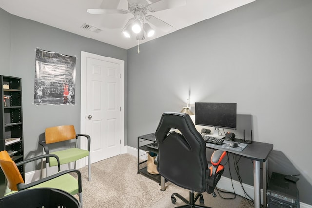 carpeted home office featuring ceiling fan