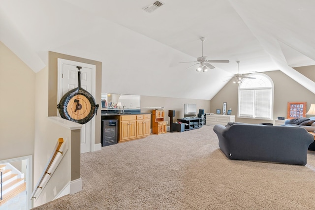 living room with carpet flooring, ceiling fan, sink, wine cooler, and vaulted ceiling