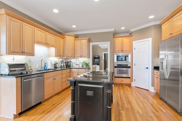 kitchen featuring sink, ornamental molding, light brown cabinets, and appliances with stainless steel finishes