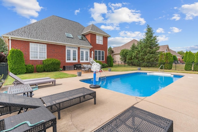 view of swimming pool featuring a lawn and a patio area