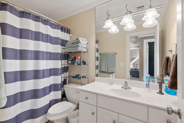 bathroom with vanity, toilet, and ornamental molding