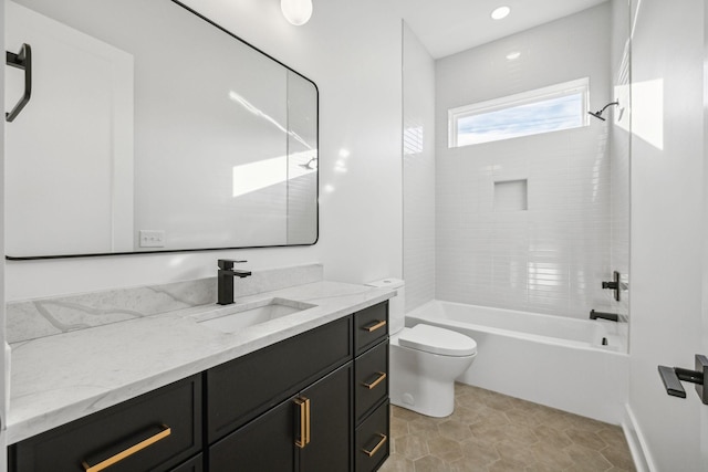 full bathroom featuring tile patterned flooring, toilet, vanity, and tiled shower / bath