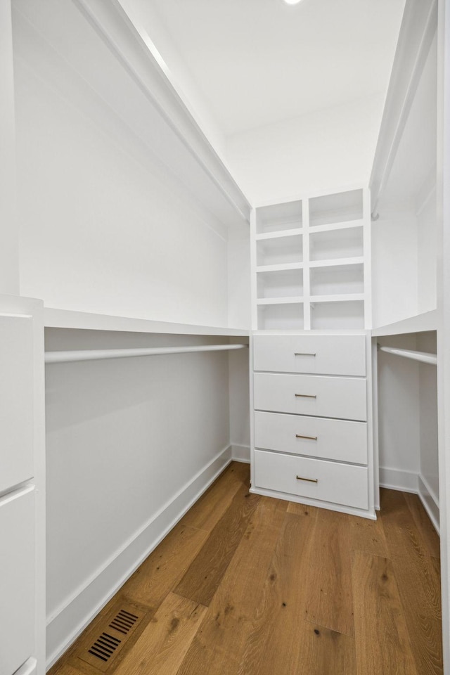 spacious closet with hardwood / wood-style floors