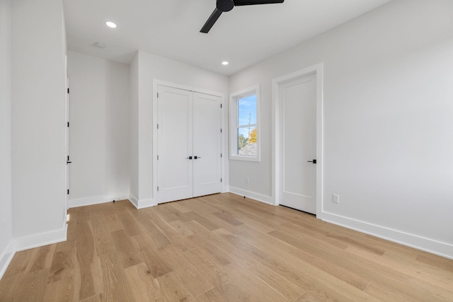 unfurnished bedroom featuring ceiling fan and light hardwood / wood-style flooring