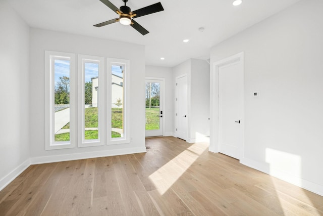 empty room featuring ceiling fan and light hardwood / wood-style flooring