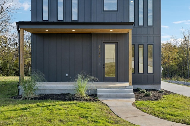 doorway to property with a yard