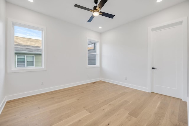 spare room featuring ceiling fan and light hardwood / wood-style flooring