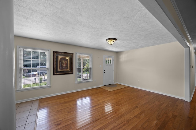 entrance foyer with plenty of natural light, hardwood / wood-style floors, and a textured ceiling