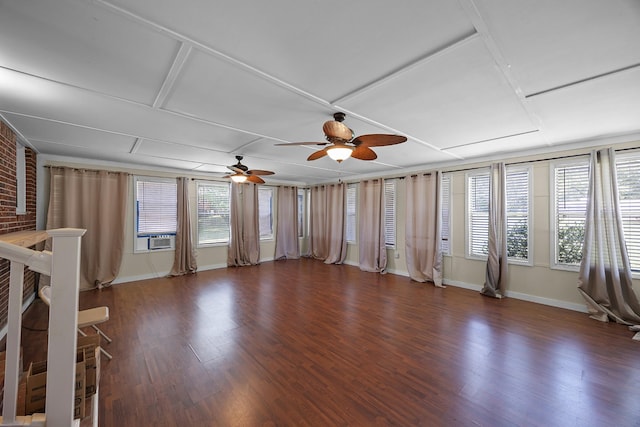 unfurnished living room with plenty of natural light, dark hardwood / wood-style floors, ceiling fan, and cooling unit