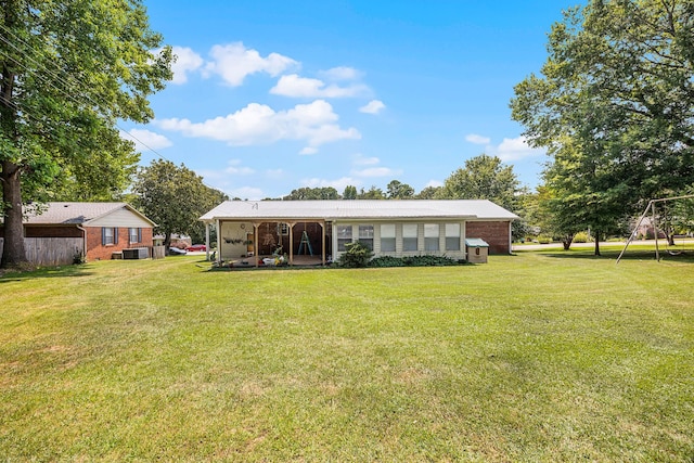 rear view of property with a lawn