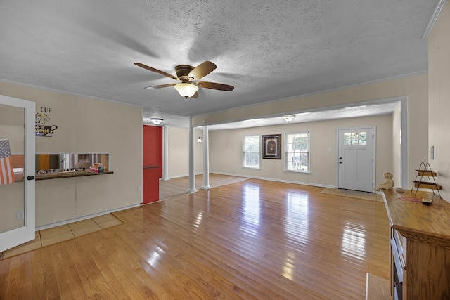 interior space featuring a textured ceiling, light wood-type flooring, and ceiling fan